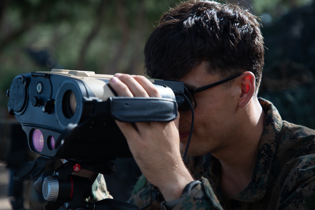 U.S. Marine Corps Cpl. David Schodowski observes a naval vessel through a Recon B2-FO Dual Channel Day/Night Thermal Biocular during a training evolution at Marine Corps Training Area Bellows, Hawaii, Jan. 23, 2024. The training experimented with the Littoral Reconnaissance Team concept while operating multiple advanced data collection systems and assets, such as the Stalker VXE30 small unmanned aerial system. Schodowski, a native of San Diego, is a scout sniper with 3d Littoral Combat Team, 3d Marine Littoral Regiment, 3d Marine Division. (U.S. Marine Corps photo by Sgt. Jacqueline C. Parsons)