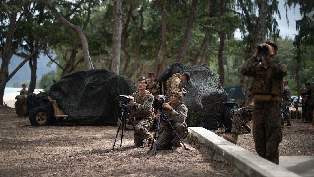 U.S. Marines with 3d Littoral Combat Team, 3d Marine Littoral Regiment, 3d Marine Division confirm visual identification of a naval vessel during a training evolution at Marine Corps Training Area Bellows, Hawaii, Jan. 24, 2024. The training experimented with the Littoral Reconnaissance Team concept while operating multiple advanced data collection systems and assets, such as the Stalker VXE30 small unmanned aerial system. (U.S. Marine Corps photo by Sgt. Jacqueline C. Parsons)