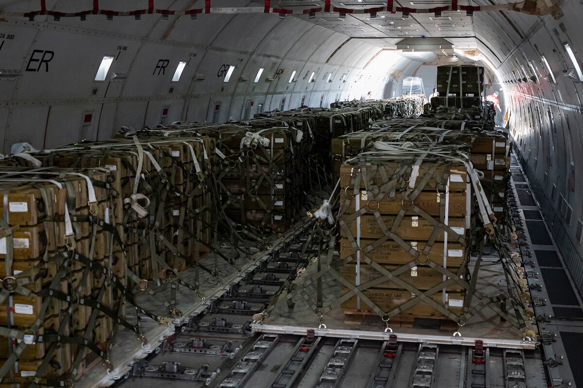 Cargo is loaded on a military cargo plane.