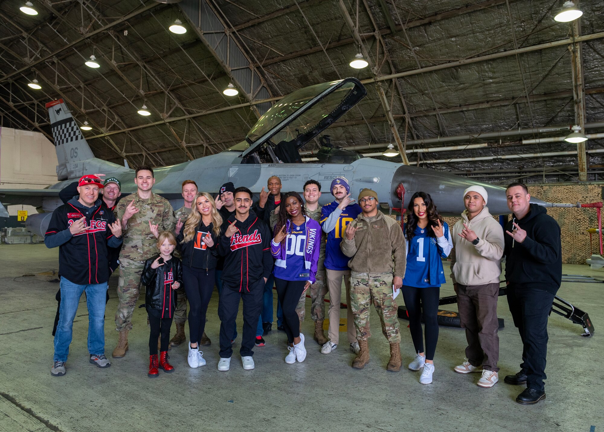 U.S. Airmen assigned to the 36th Fighter Generation Squadron and their family members take a group photo with NFL cheerleaders during the Pro Blitz 2024 unit visit at Osan Air Base, Republic of Korea, Feb. 10, 2024. NFL players, cheerleaders and mascots visited more than 200 military bases in five regions across the globe as part of Armed Forces Entertainment's Pro Blitz Tour. (U.S. Air Force photo by Staff Sgt. Aubree Owens)