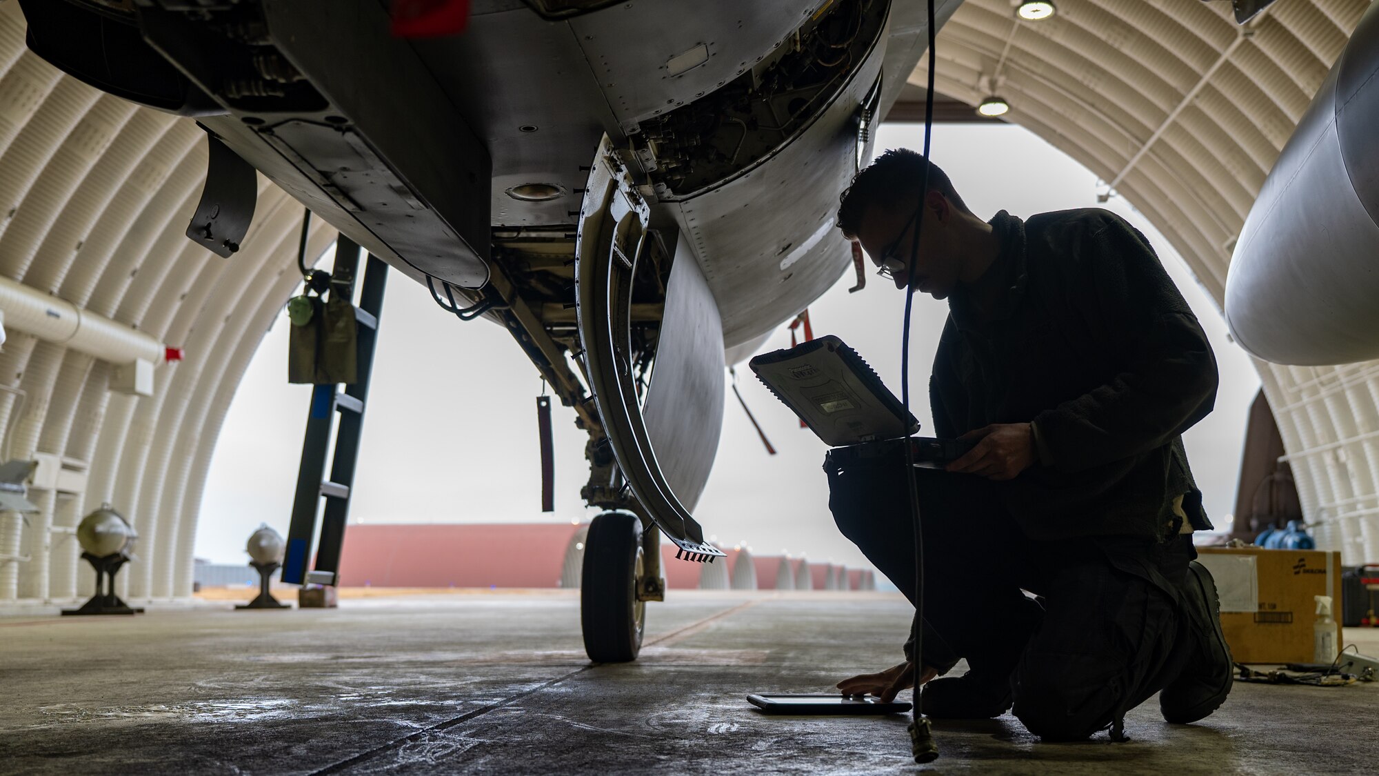 Staff Sgt. Devin Baker services an F-16 Fighting Falcon at Kunsan Air Base.