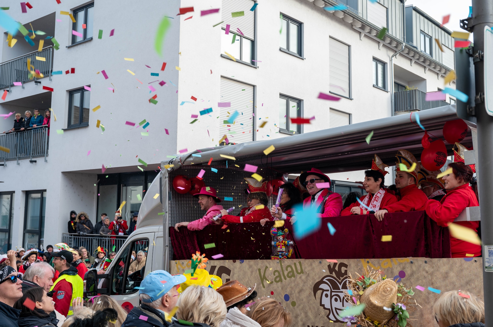 A van moves on street, confetti in air