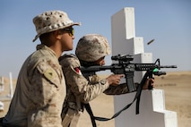 240130-M-IU565-1521 CAMP BUEHRING, Kuwait (Jan. 30, 2024) A Marine assigned to Fleet Anti-Terrorism Security Team Central Command observes a Kuwaiti soldier firing his weapon while participating in live-fire rifle training during exercise Eager Defender 24 onboard Camp Buehring, Kuwait, Jan. 30. Eager Defender 24 is the capstone in a series of bilateral exercises between Kuwait and U.S. naval forces, focused on enhancing mutual capabilities and interoperability in maritime security operations.