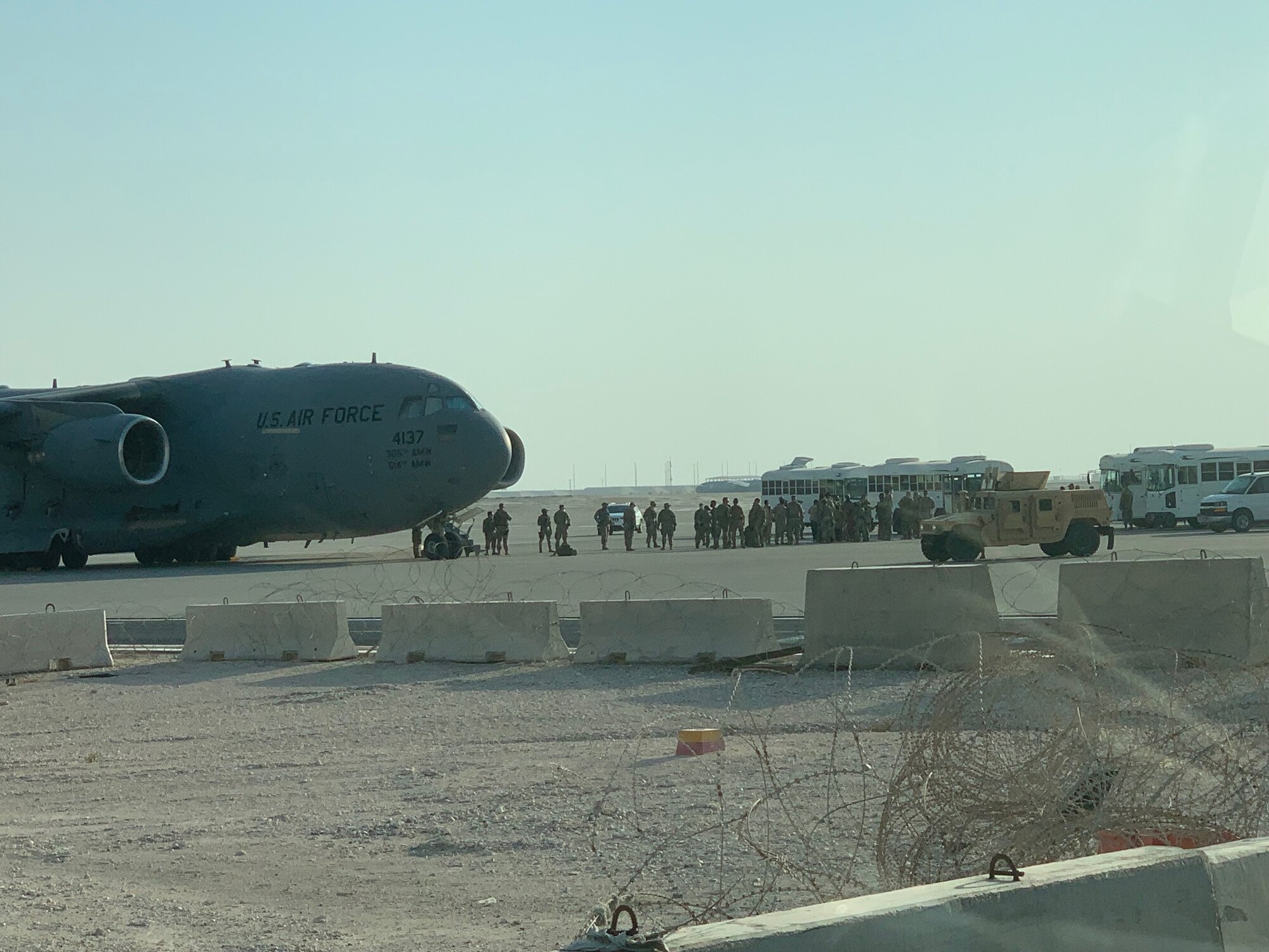 Afghan refugees depart from a C-17 Globemaster III during Operation Allies Refuge in August of 2021 at Al Udeid Air Base, Qatar. Twenty-three McConnell Airmen received Air Medal-Combat Devices for their participation in the evacuation. (Courtesy Photo)
