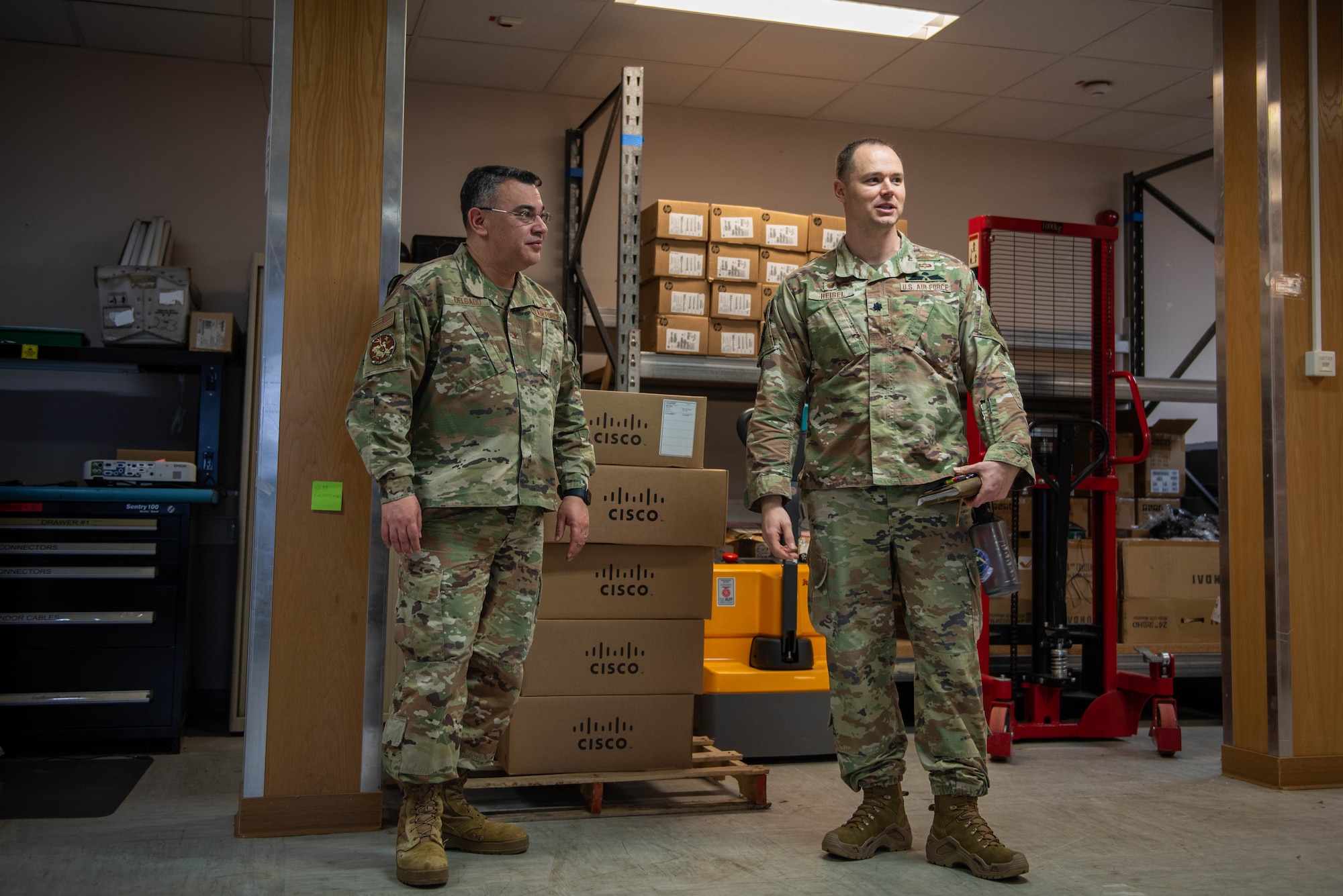 U.S. Air Force Col. Oscar Delgado, the U.S. Air Forces in Europe - Air Forces in Africa A6 director, and Lt. Col. Thomas Heisel, 52nd Communications Squadron commander, view a storage facility during a base visit at Spangdahlem Air Base, Germany, Jan. 24, 2024.