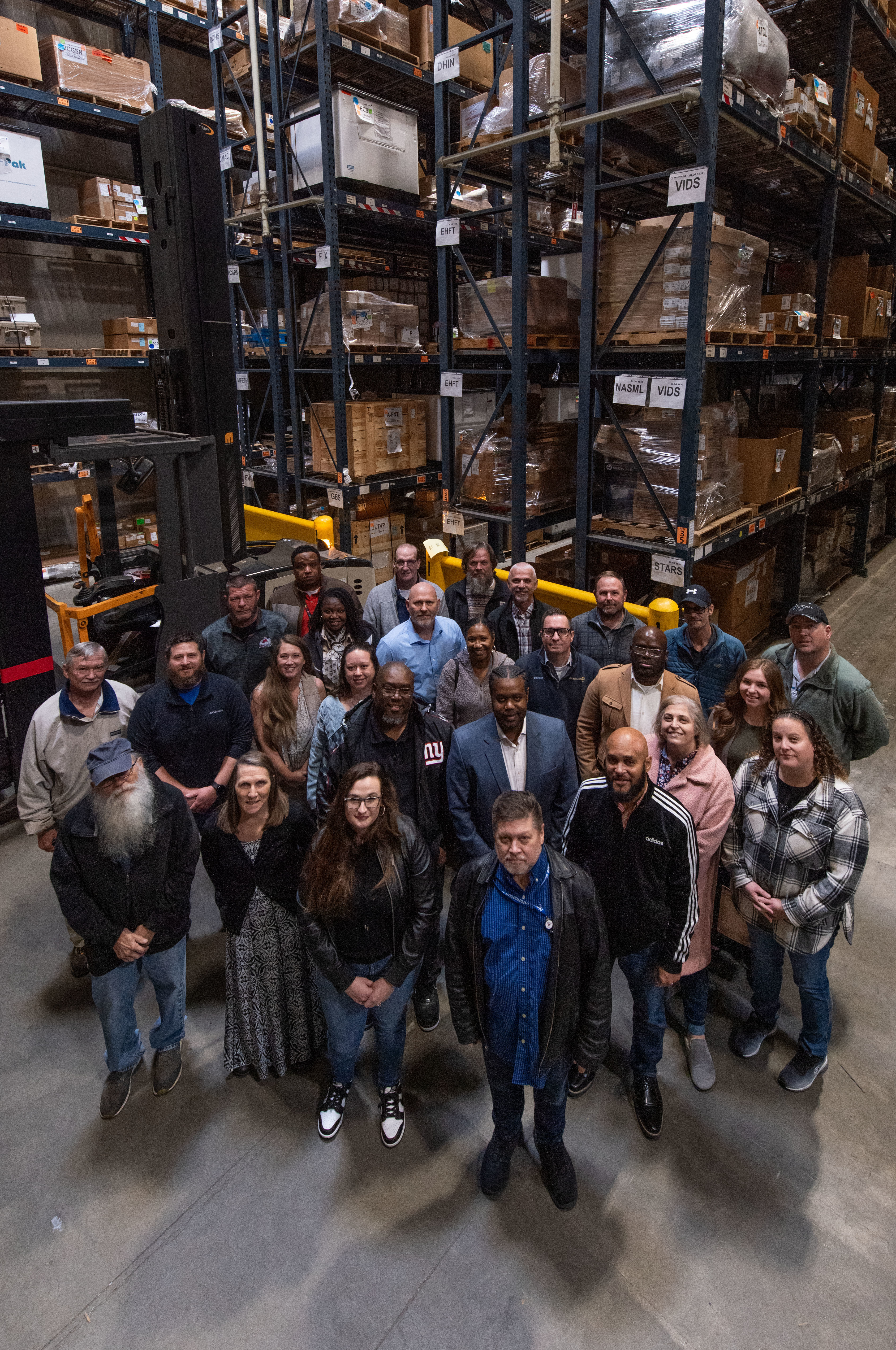 Members of Naval Information Warfare Center (NIWC) Atlantic’s Supply Chain Management (SCM) Service Center pose for a group photo at one of the center’s logistics hubs in Charleston, South Carolina. The SCM Service Center has been able to keep rates steady over the past four years by cutting costs, all while maintaining optimal service levels. (U.S. Navy photo by Joe Bullinger)