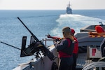 Sailors stand watch as ship, along with other ships of Dwight D. Eisenhower Carrier Strike Group, transit Strait of Hormuz