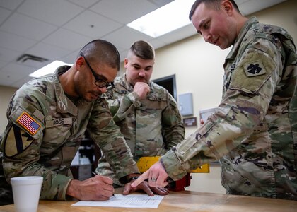 (From left to right) Oklahoma Army National Guardsmen Sgt. 1st Class Brandon Rose, an ammunition specialist assigned to Headquarters Company, 700th Brigade Support Battalion, 45th Infantry Brigade Combat Team, Sgt. Daniel Jones, a wheeled vehicle mechanic assigned to Golf Company, 700th Brigade Support Battalion, 45th IBCT, and Sgt. Adrian Maddox, an automated logistical specialist assigned to 2120th Engineer Support Company, 120th Engineer Battalion, 90th Troop Command, take a written exam during the Mechanic of the Year competition held at the Combined Support Maintenance Shop in Norman, Oklahoma, Feb. 7, 2024. The Guardsmen gathered to put their mechanic skills to the test in the third annual competition, working in four-man teams to beat out the competition while also getting to network amongst fellow competitors. (Oklahoma National Guard photo by Cpl. Danielle Rayon)