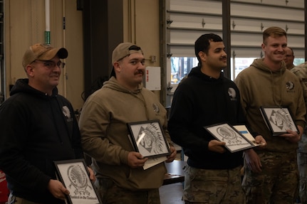 (From left to right) Oklahoma Army National Guardsman Staff Sgt. Brandon Burns, Spc. Patrick Woody, Spc. Jasser Reyes, and Sgt. Kyle Ehrenberg, a mechanic team representing the Maneuver Area Training Equipment Site out of Ft. Sill, pose with their award after winning First Overall Team at the Mechanic of the Year competition held at the Combined Support Maintenance Shop in Norman, Oklahoma, Feb. 7, 2024. The team won the title of Mechanic of the Year, after ten teams gathered to put their mechanic skills to the test in the third annual competition, while also getting to network amongst fellow competitors. (Photo courtesy of Sgt. Joe Pena)