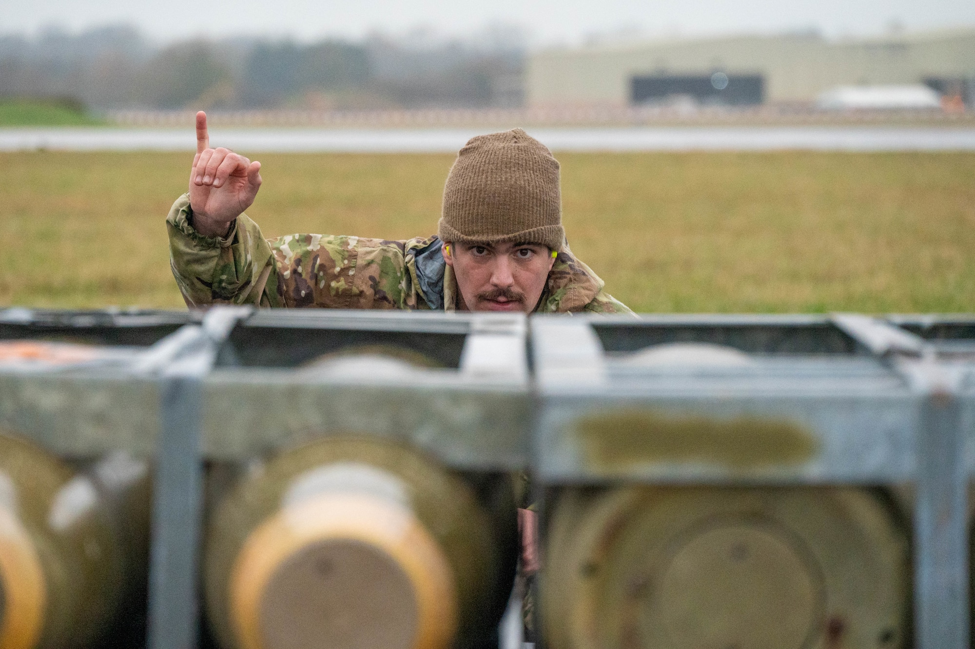 An Airman guides assets onto a pallet for airlift transport