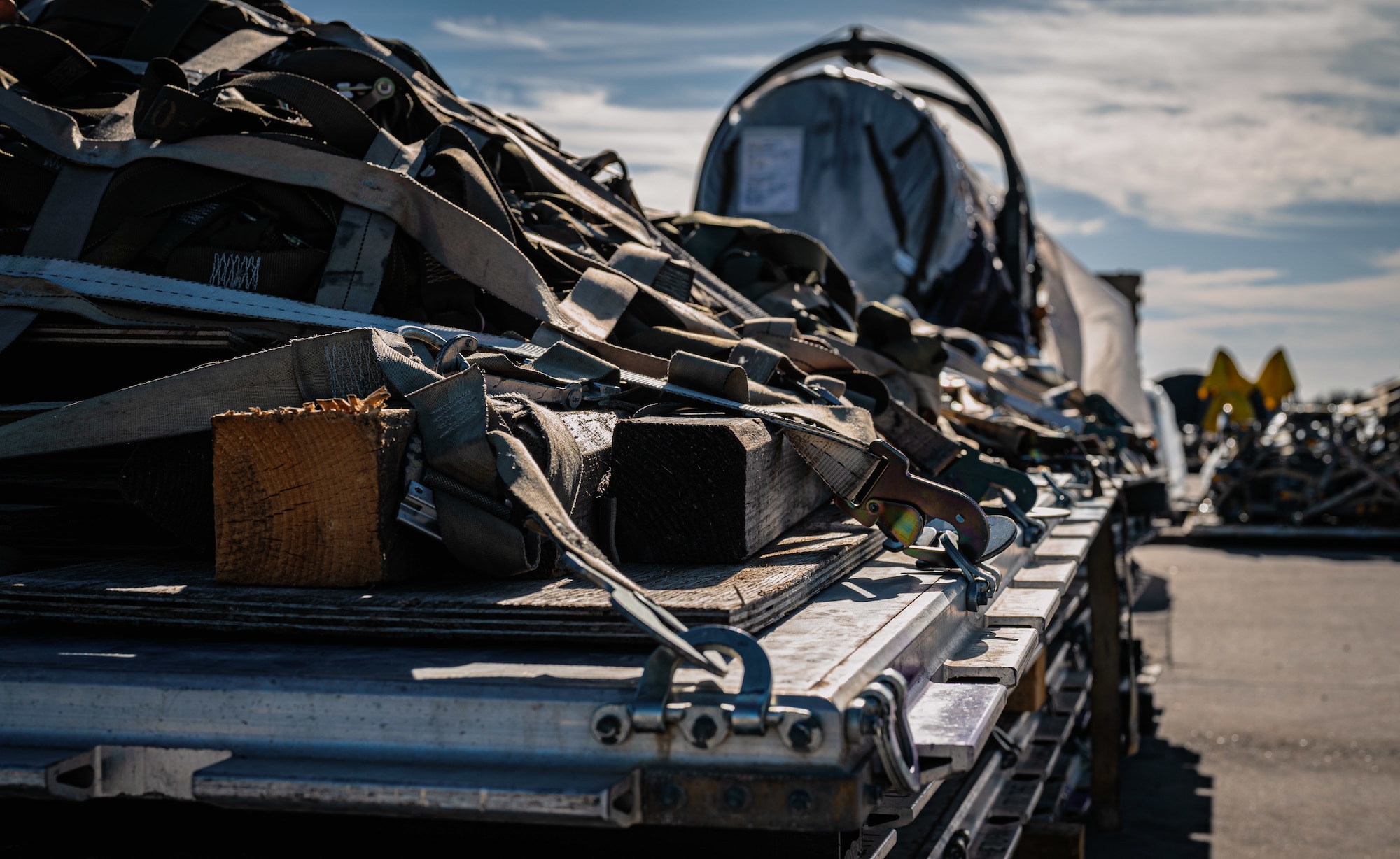 Military equipment is secured onto a bed.
