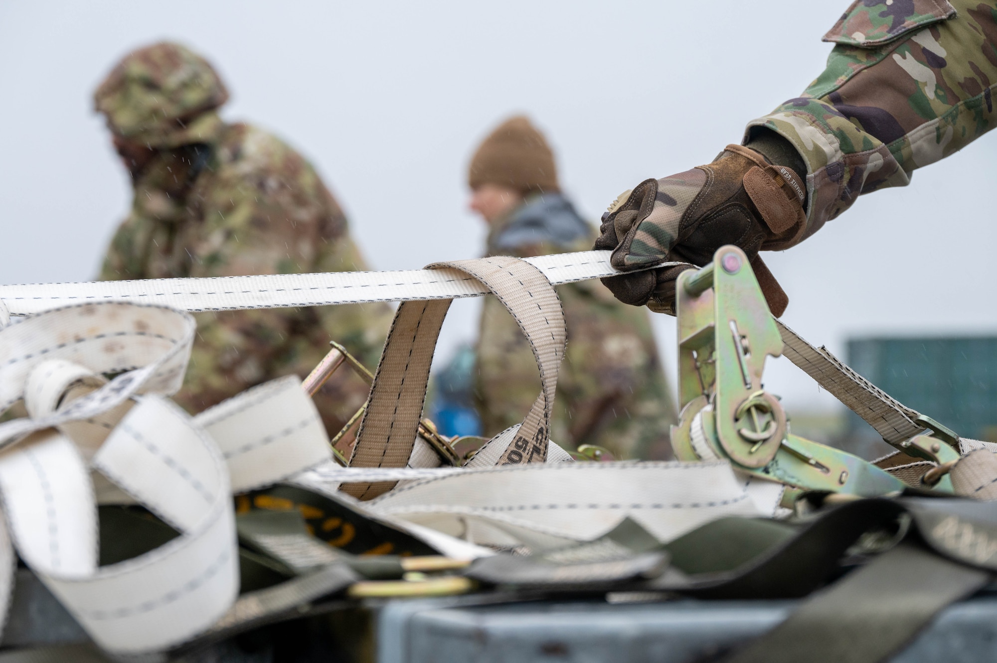 A gloved hand grips a tether