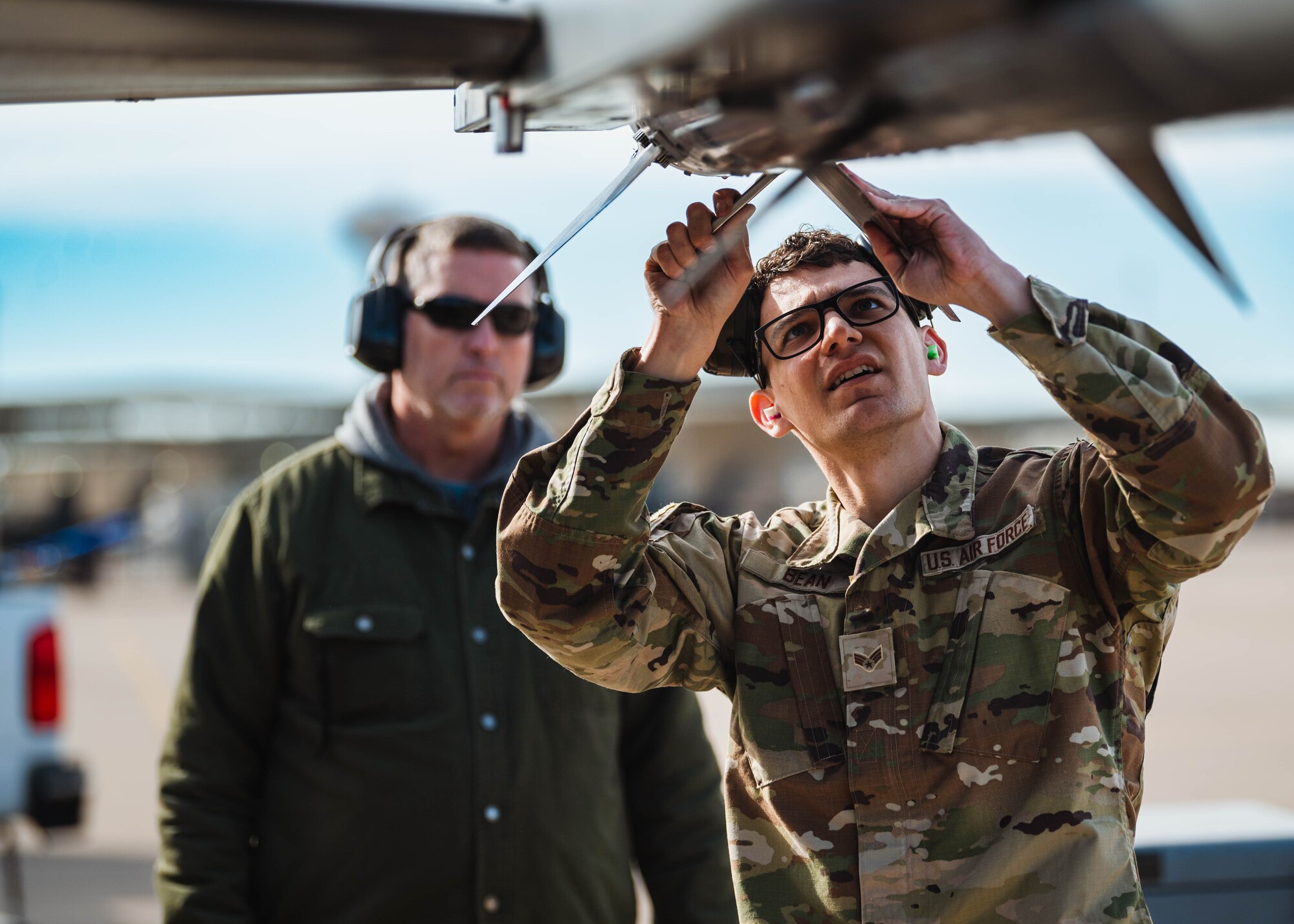 U.S. Air Force Senior Airman Noah Bean, 309th Fighter Squadron weapons load crew member, prepares an AIM-120 Advanced Medium-Range Air-to-Air Missile bomb for a U.S. Air Force F-16 Fighting Falcon during the annual weapons load competition.