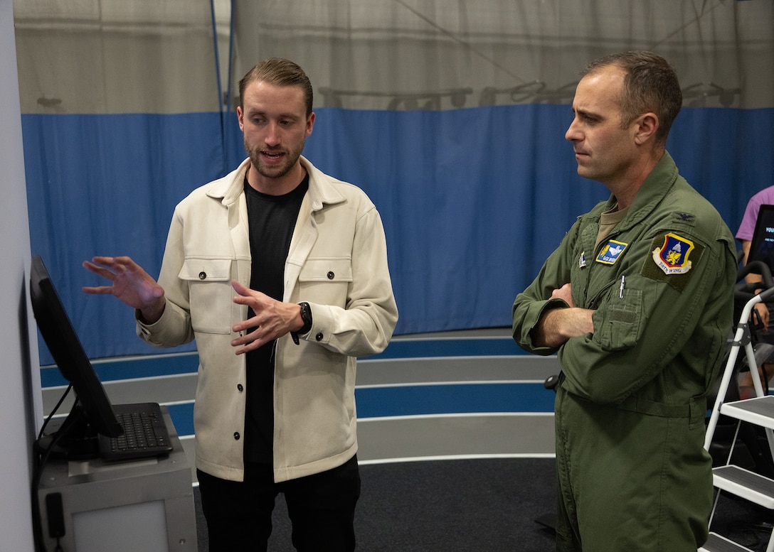 Brandon Murphy, left, head of growth at Lumena, speaks to U.S. Air Force Col. Parkin C. “Gage” Bryson, 316th Wing deputy commander, on how to set up a MindGym account at the Tactical Fitness Center at Joint Base Andrews, Md., Feb. 9, 2024.