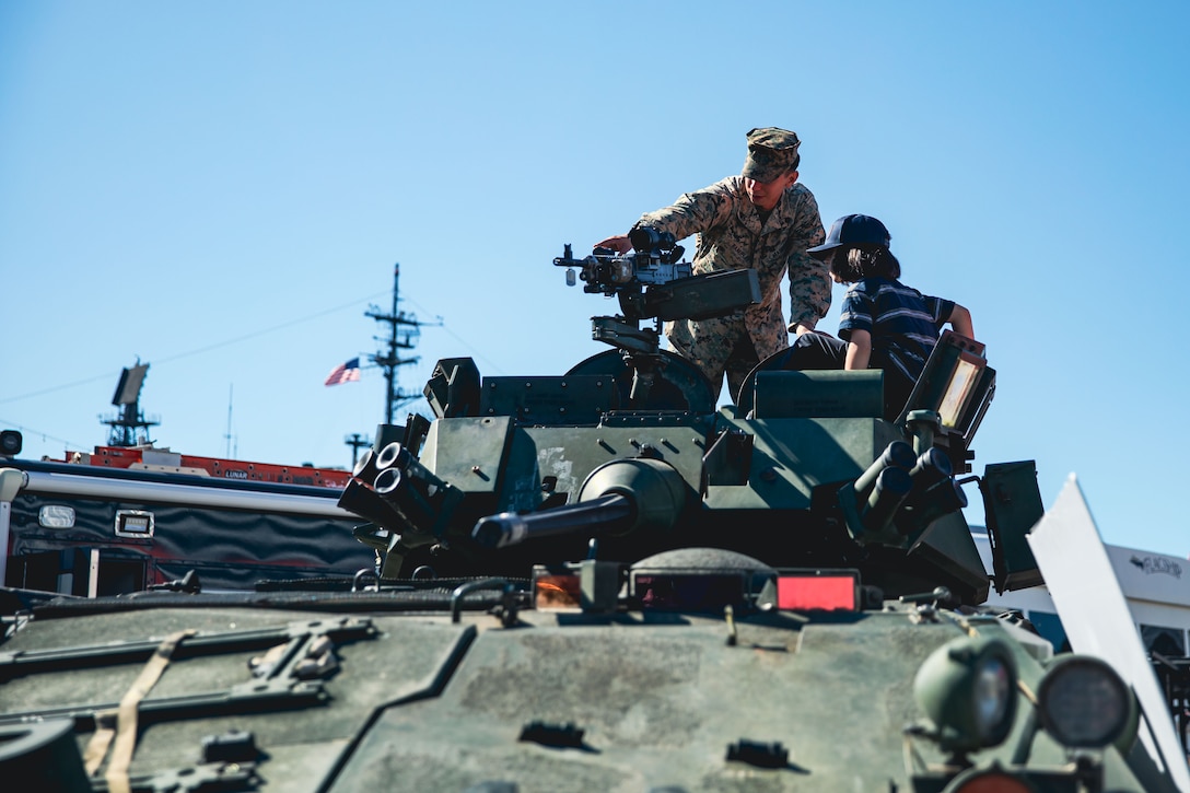 A U.S. Marine gives tours to visitors around the light armored vehicle (LAV25) during Fleet Week San Diego (FWSD) 2023. FWSD is an opportunity for the San Diego residents and tourists to meet their Navy, Marine Corps and Coast Guard teams and experience America’s sea services. During fleet week, service members participate in various community relations events, showcase capabilities and equipment to the community, and enjoy the hospitality of San Diego and its surrounding areas. (U.S. Navy photo by Mass Communication Specialist 3rd Class Kevin Tang)