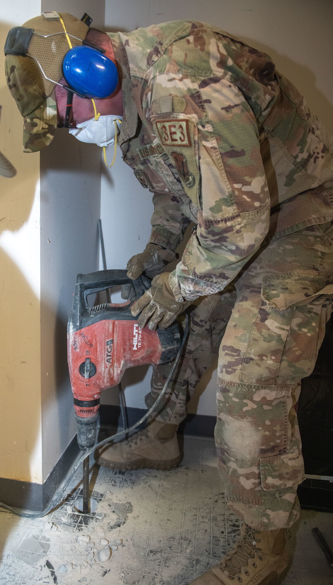 Airman drilling a hole