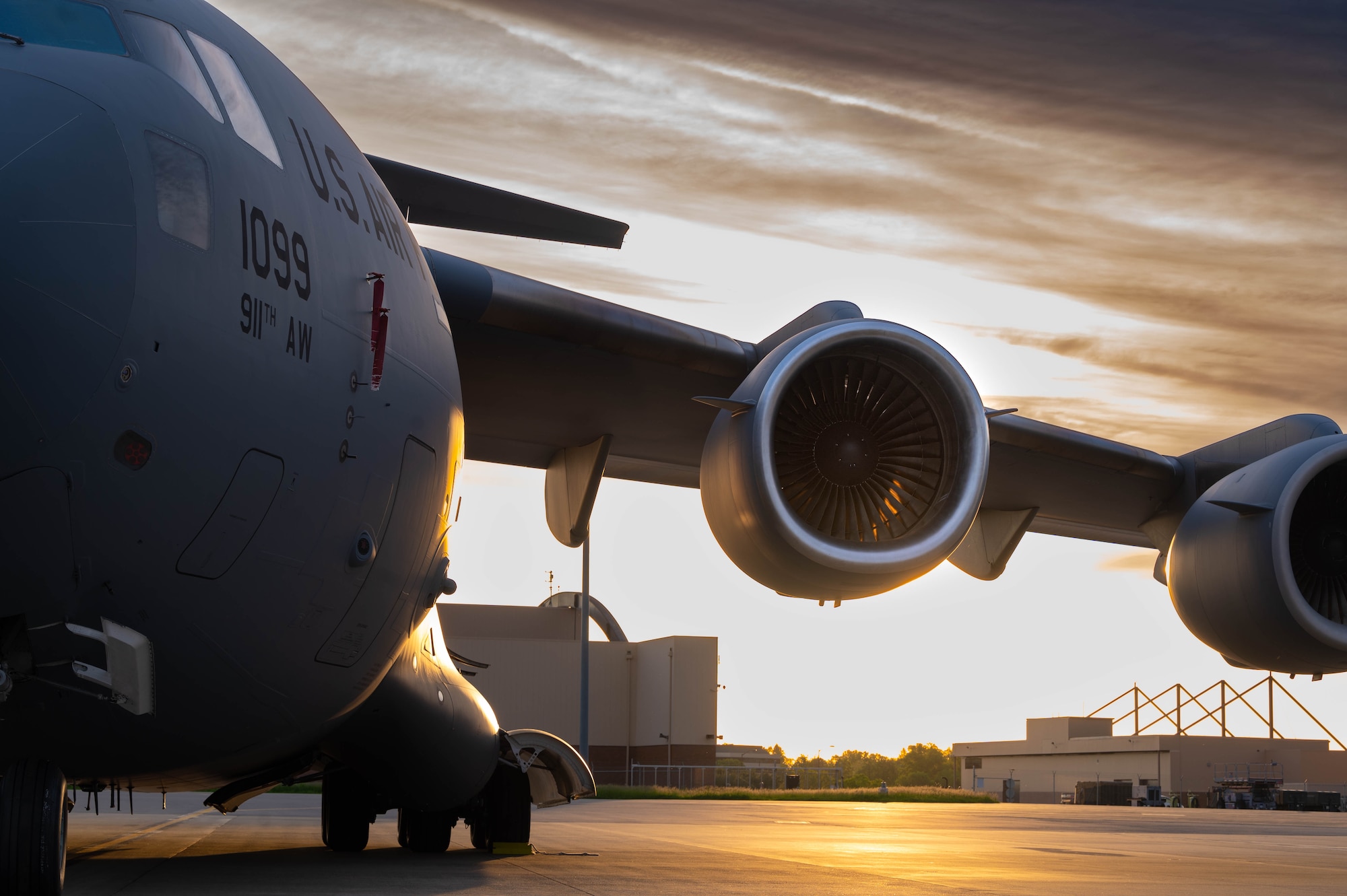 The sun rises on a C-17 Globemaster III aircraft, assigned to the 911th Airlift Wing, May 15, 2023, at the Pittsburgh International Air Port Air Reserve Station, Pennsylvania. The C-17 has global reach capabilities when combined with in-flight refueling. (U.S. Air Force photo by Master Sgt. Jeffrey Grossi)