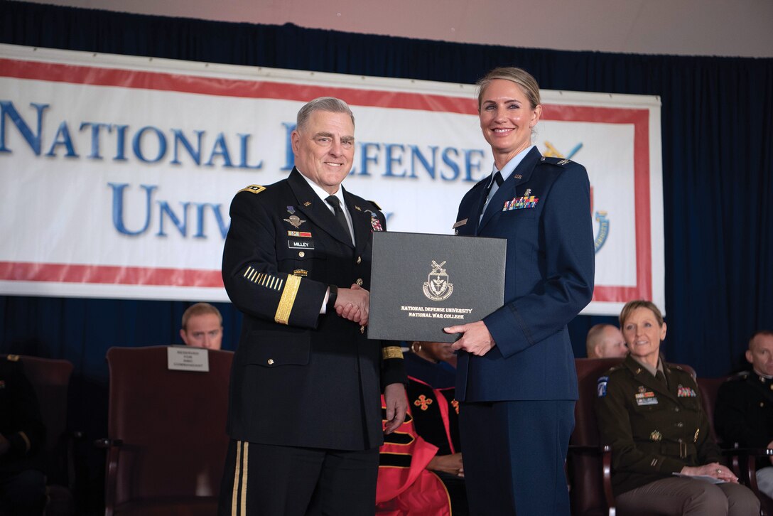 Then Chairman of the Joint Chiefs of Staff General Mark A. Milley congratulates National War College graduate during National Defense University’s 2023 graduation ceremony