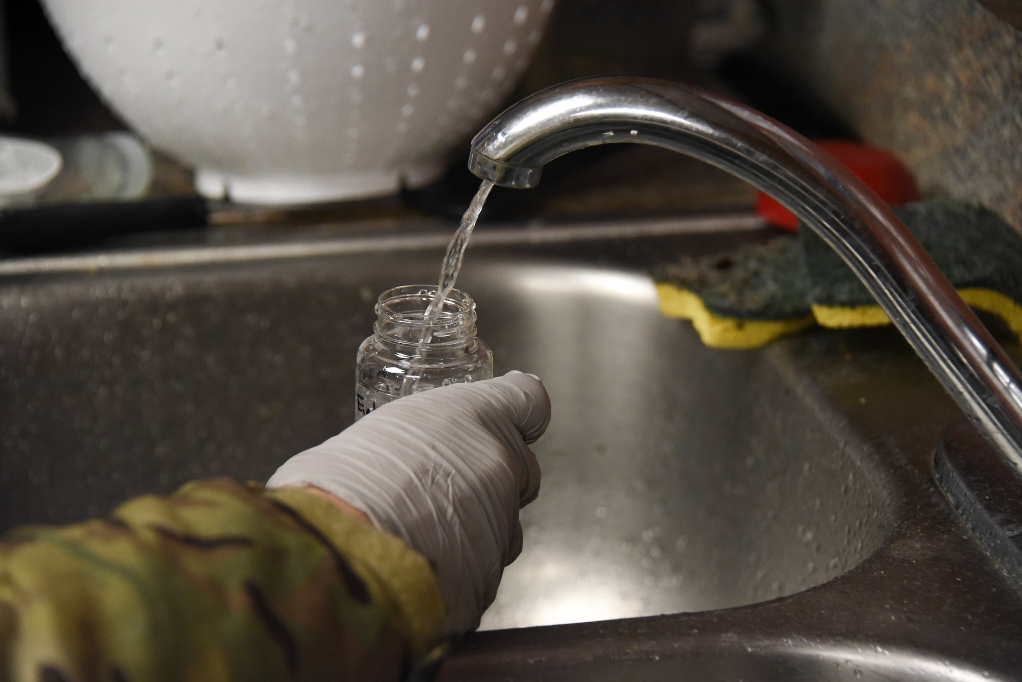 Airman collects water sample