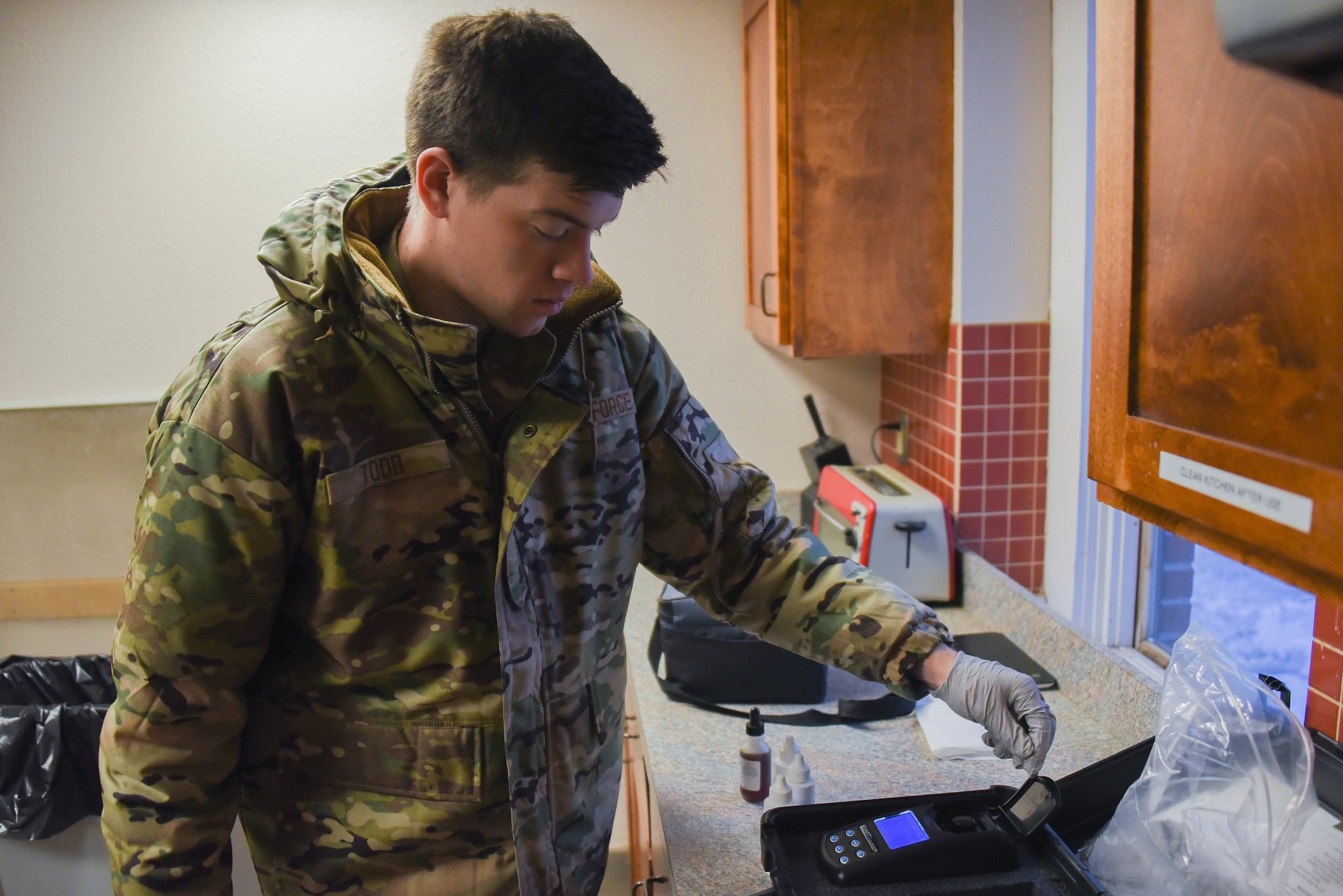 Airman tests water sample