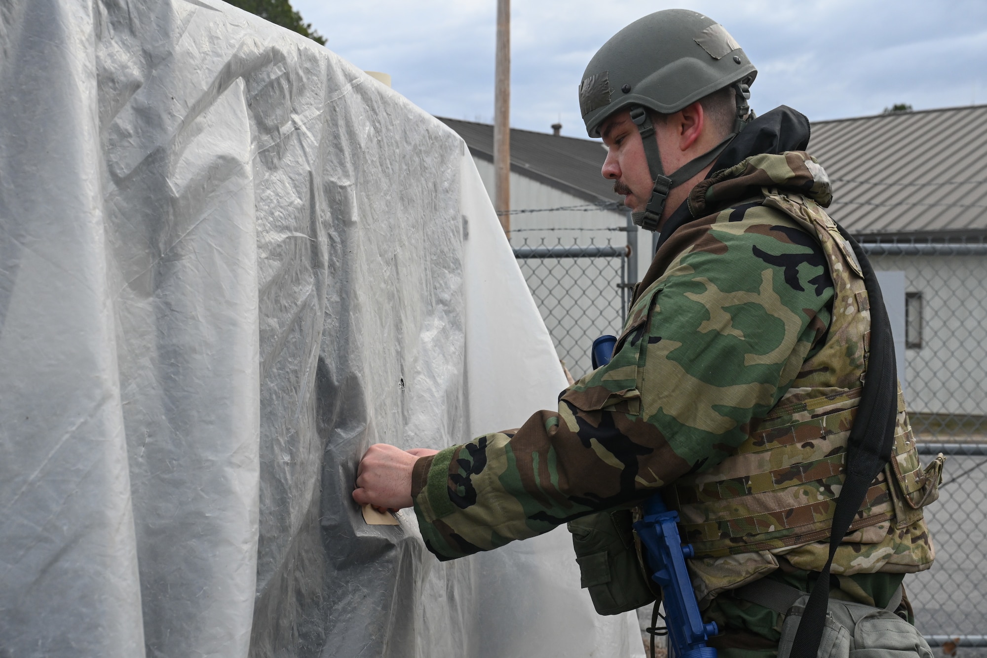 A man sticks a M8 Chemical Detection Paper on a asset.