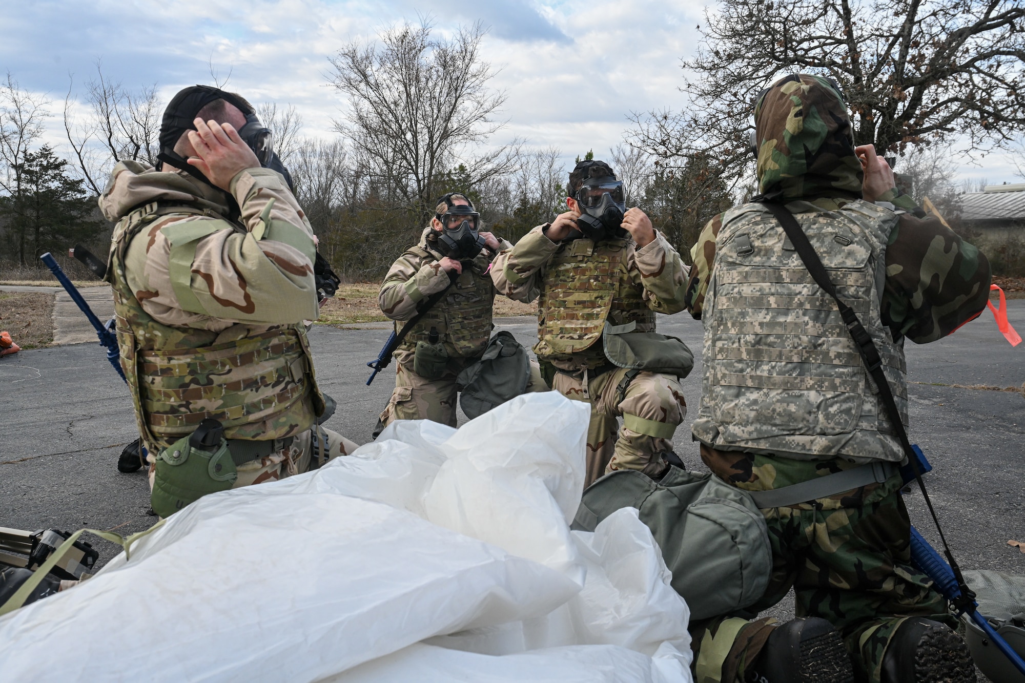 Airmen put on gas masks during an exercise.