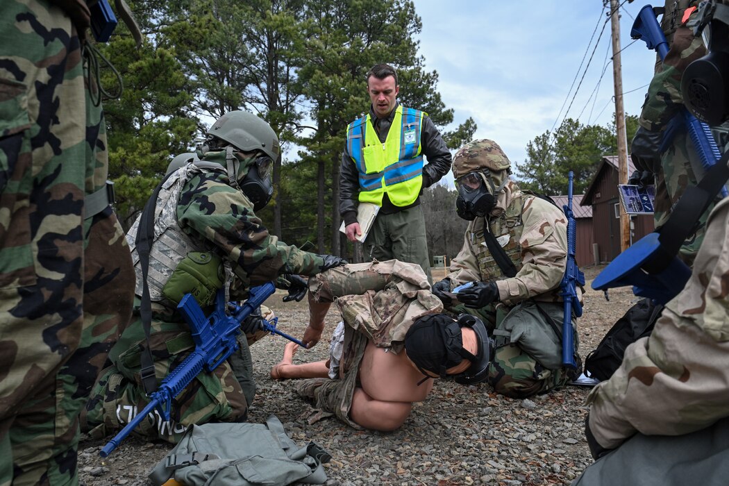 Airmen perform Tactical Combat Casualty Care on a simulated patient.