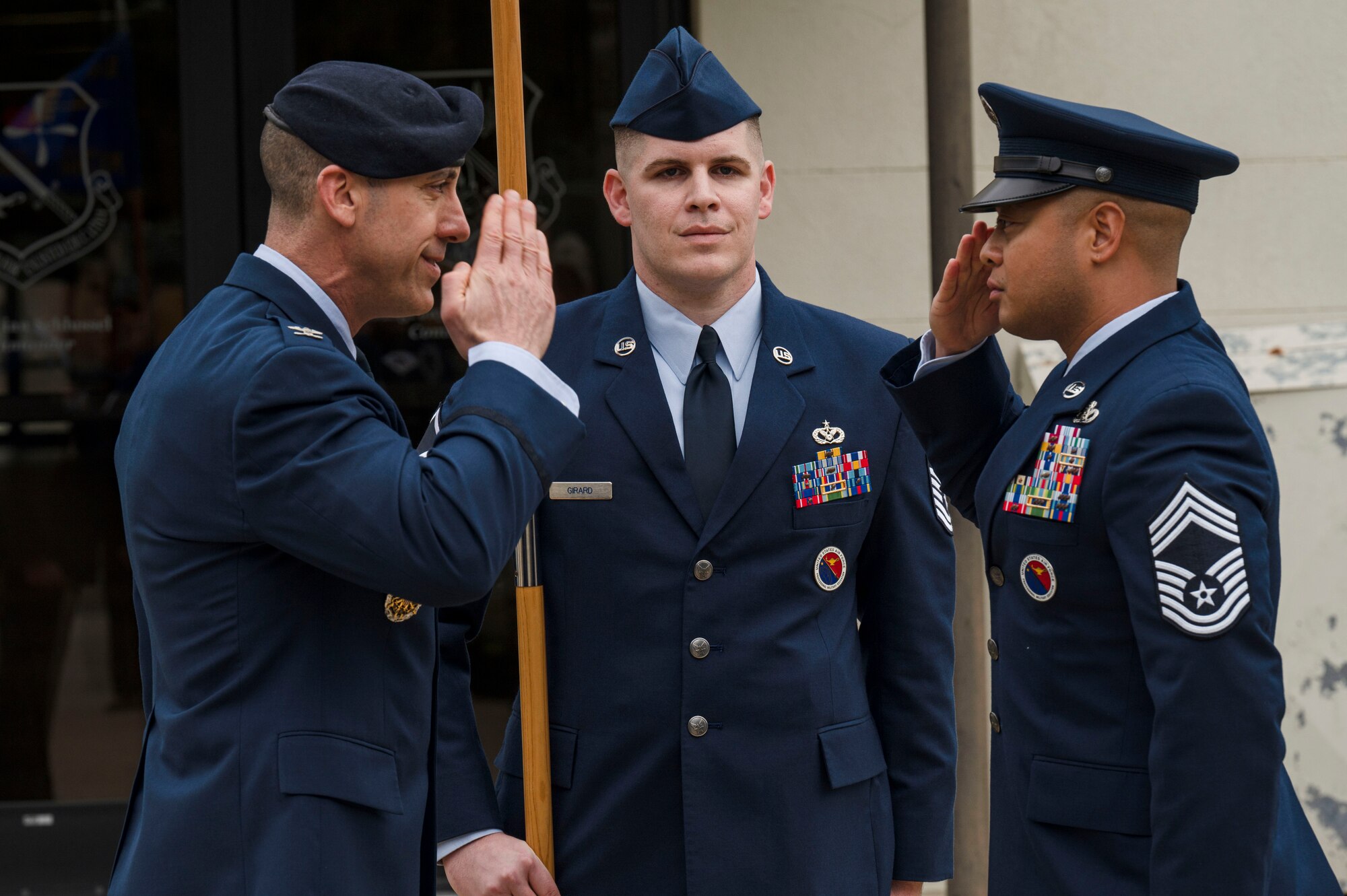 U.S. Air Force Col. Damian Schlussel, Thomas N. Barnes Center for Enlisted Education commander, and Chief Master Sgt. Jayar Dela Cruz, Mathies Noncommissioned Officer Academy commandant, salute during the assumption of responsibility and ribbon cutting ceremony on Keesler Air Force Base, Mississippi, Feb. 8, 2024.