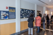 Invited guests read and learn about the career of a U.S. Navy icon, Raye Montague, in West Bethesda, Md