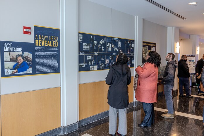 Invited guests read and learn about the career of a U.S. Navy icon, Raye Montague, in West Bethesda, Md