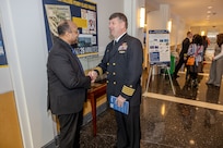 Naval Surface Warfare Center, Carderock Division Commanding Officer Capt. Matthew Tardy (right) speaks to Dr. David Montague, the son of Navy icon Raye Montague.