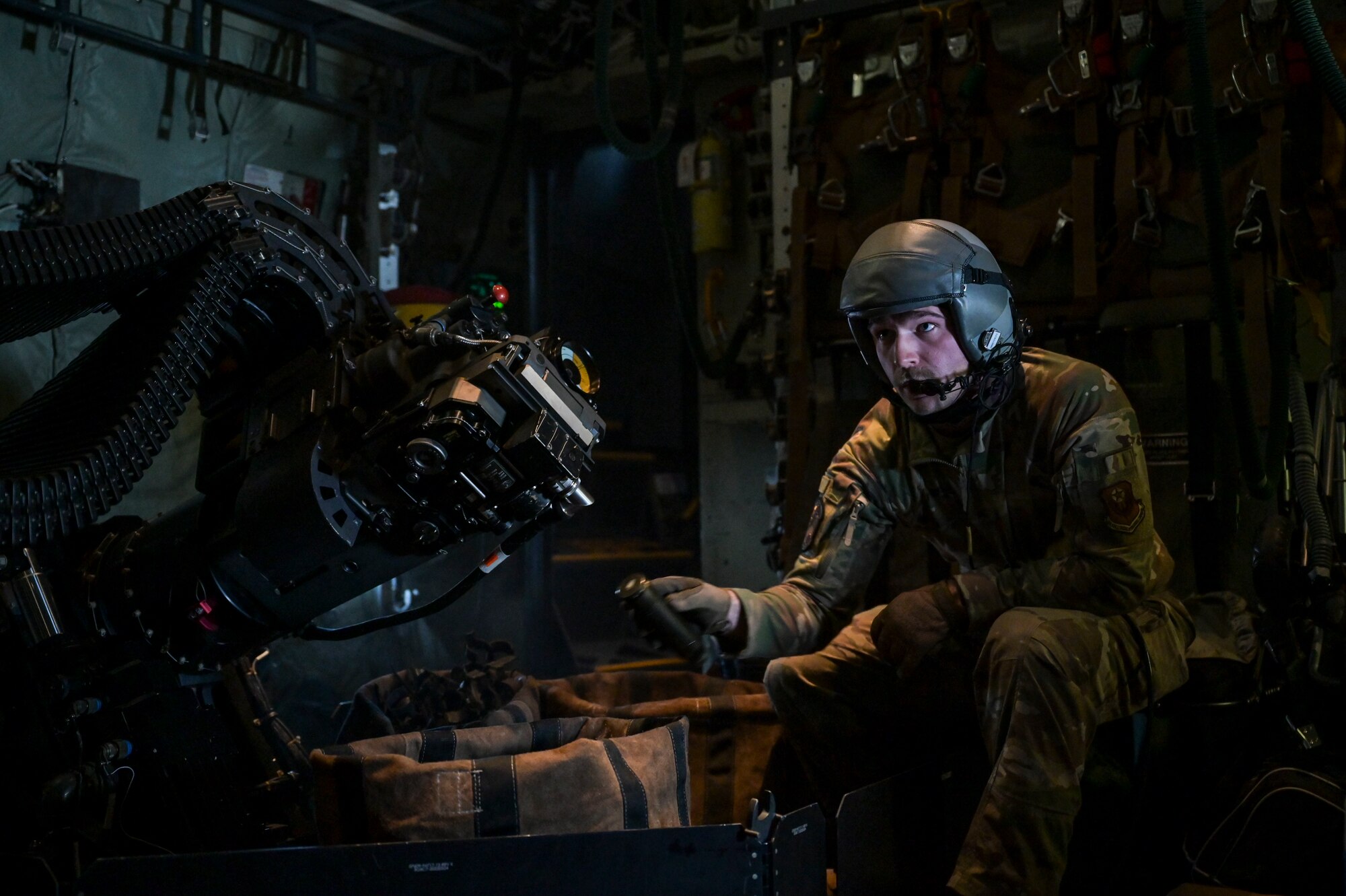 U.S. Air Force Senior Airman Nathan Staso, a 73rd Special Operations Squadron special mission aviator, picks up expended rounds from a 30mm cannon on an AC-130J Ghostrider gunship during Agile Ghost near Hurlburt Field