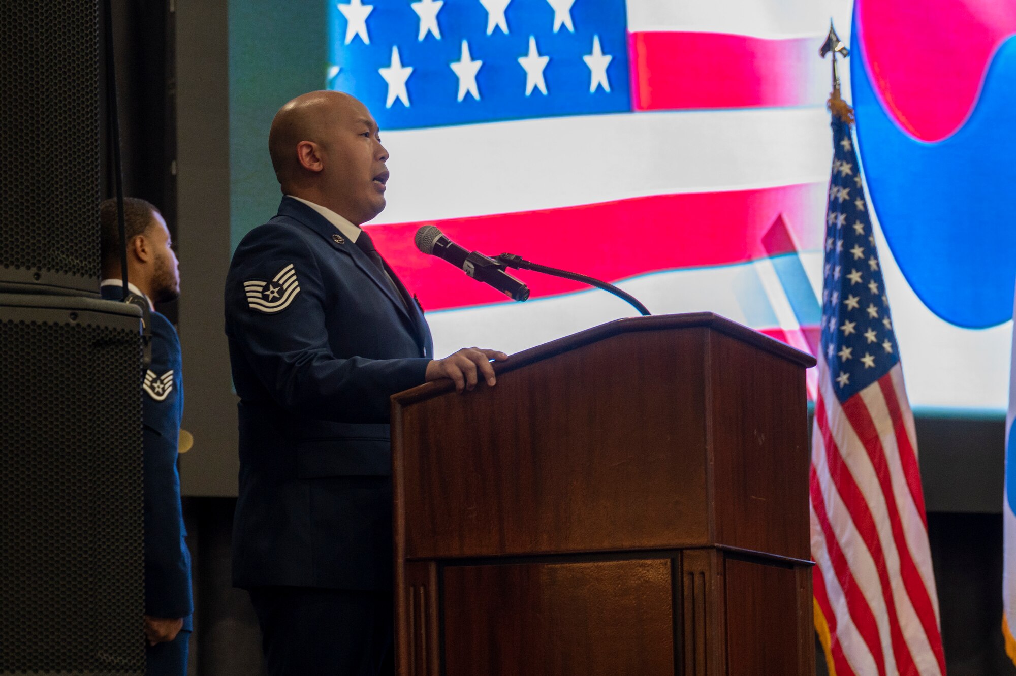 U.S. Air Force Tech Sgt. Timothy Mims, 51st Maintenance Squadron Electronics non-commissioned officer in charge, sings the national anthem during the Airman Leadership School Class 24-A graduation at Osan Air Base, Republic of Korea, Feb. 15, 2024. ALS is the first level of professional military education for enlisted Airmen. It serves as an entry-level leadership enhancement course, designed to prepare Airmen for leadership positions within the USAF. (U.S. Air Force photo by Senior Airman Kaitlin Castillo)