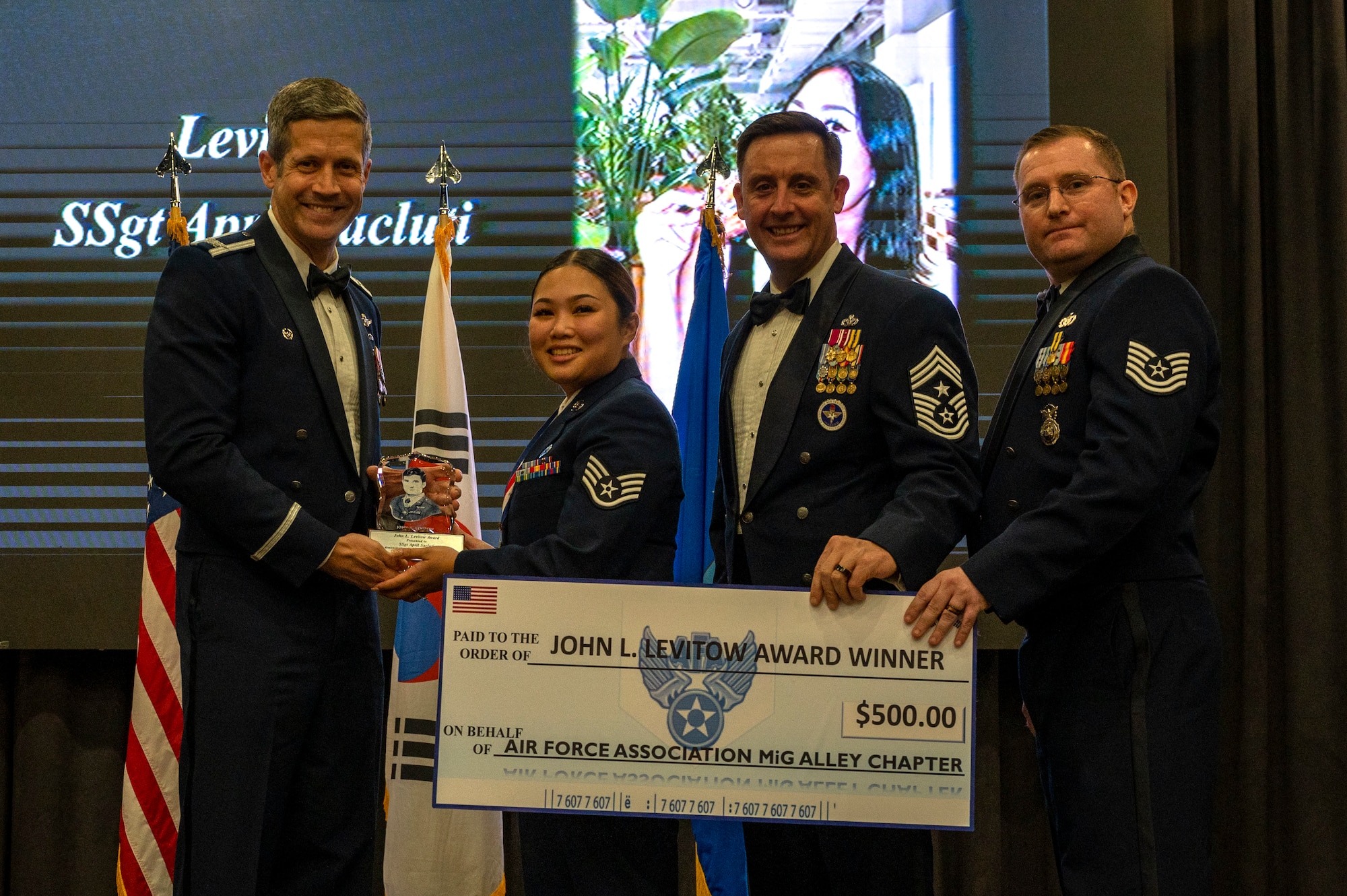 U.S. Air Force Staff Sgt. April Sacluti, 51st Maintenance Group unit training manager, is presented with the John L. Levitow Award during the Airman Leadership School Class 24-A graduation at Osan Air Base, Republic of Korea, Feb. 15, 2024. The Levitow Award is the highest award presented to the student that demonstrates the most outstanding leadership and scholastic qualities. (U.S. Air Force photo by Senior Airman Kaitlin Castillo)