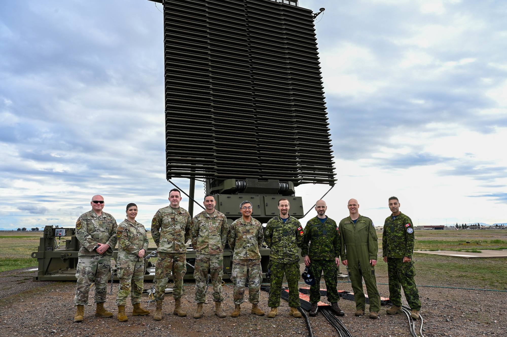 U.S. Air Force Airmen from the 607th Air Control Squadron and Royal Canadian Air Force airmen from 4 Wing, Canadian Forces Base Cold Lake, Alberta, stand in front of an AN/TPS-77 radar system during exercise Phoenix Sunrise, Jan. 19 - Feb. 17, 2024, at Luke Air Force Base, Arizona.