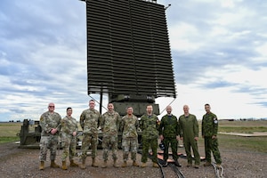 U.S. Air Force Airmen from the 607th Air Control Squadron and Royal Canadian Air Force airmen from 4 Wing, Canadian Forces Base Cold Lake, Alberta, stand in front of an AN/TPS-77 radar system during exercise Phoenix Sunrise, Jan. 19 - Feb. 17, 2024, at Luke Air Force Base, Arizona.