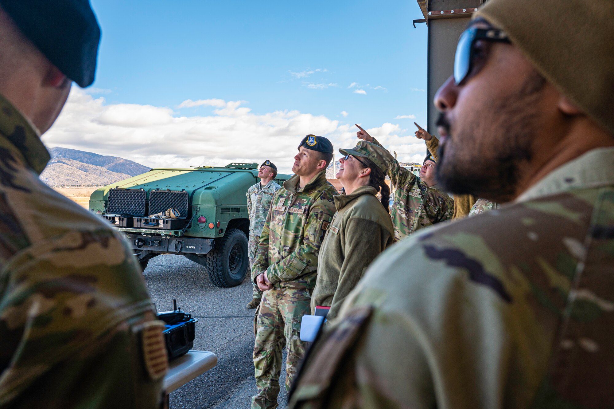 A woman watches a drone.