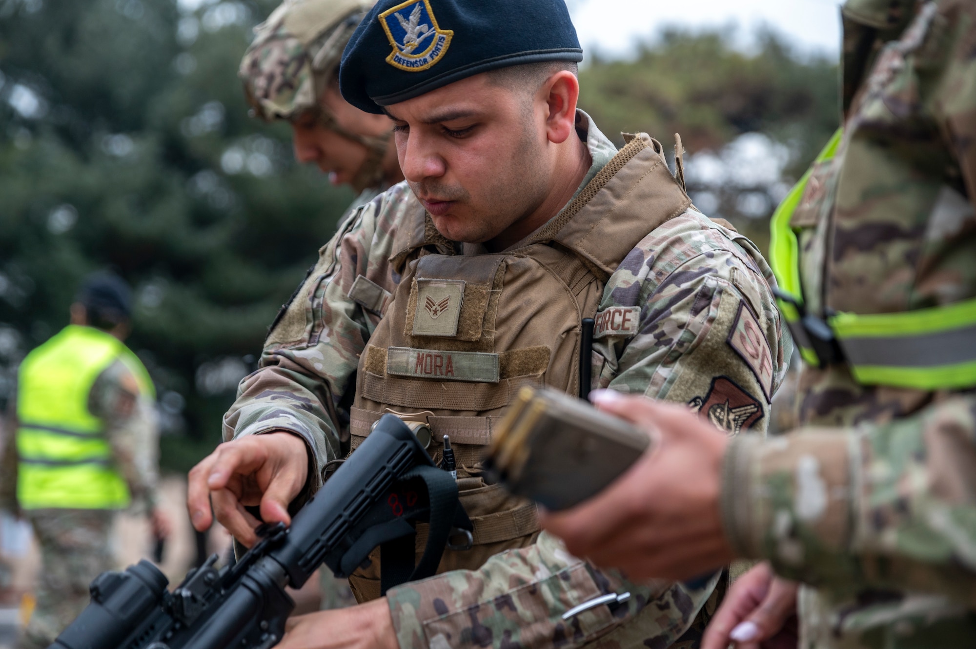U.S. Air Force Senior Airman Andre Mora, 51st Security Forces Squadron defender, returns his training rifle after participating in a simulated active shooter response training at Osan Air Base, Republic of Korea, Feb. 14, 2024. Regular contingency training, alongside realistic scenarios, prepares defenders for any situation ensuring Osan AB remains secure and operational. (U.S. Air Force photo by Senior Airman Trevor Gordnier)