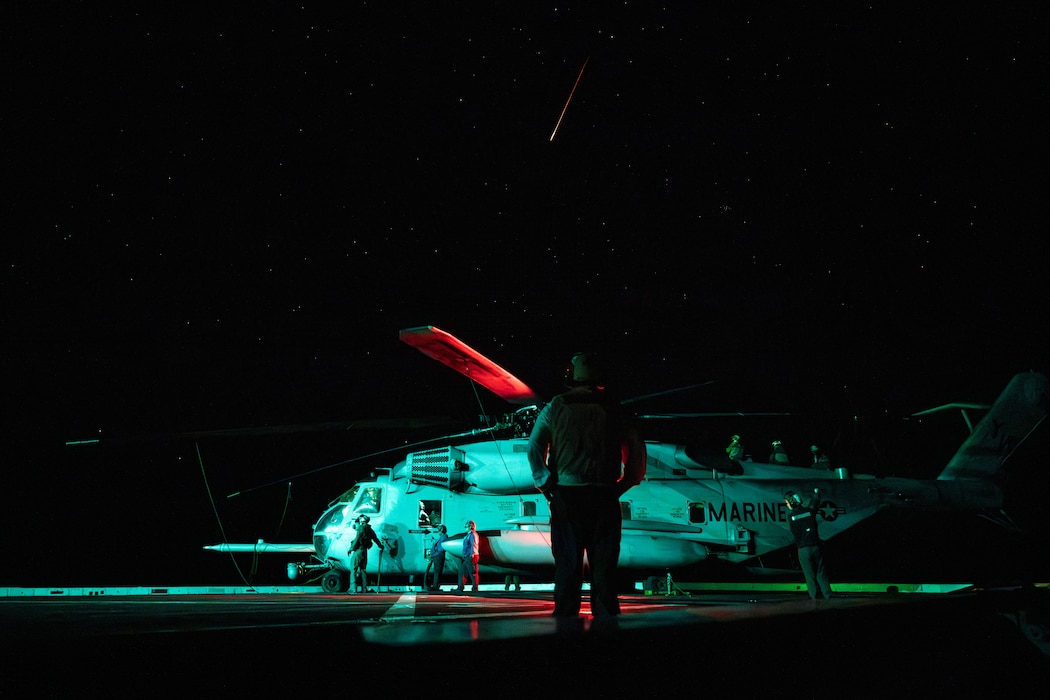 Post-flight maintenance on a CH-53E Super Stallion helicopter while underway in the Pacific Ocean.