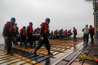 U.S. and French navy sailors carry combat rubber raiding craft aboard  USS Gunston Hall (LSD 44) during Steadfast Defender 24.