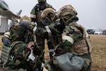 Airmen from the 155th Air Refueling Wing, respond to a simulated injured airman Feb. 4, 2024, National Guard airbase in Lincoln, Nebraska.