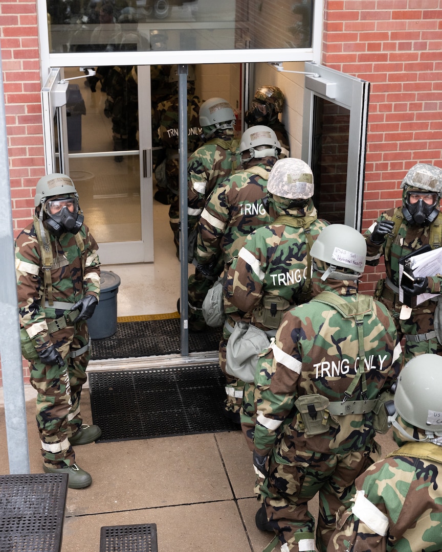 Airmen from the 155th Air Refueling Wing enter a building from a during a large-scale readiness exercise Feb. 4, 2024, on National Guard airbase in Lincoln, Nebraska.