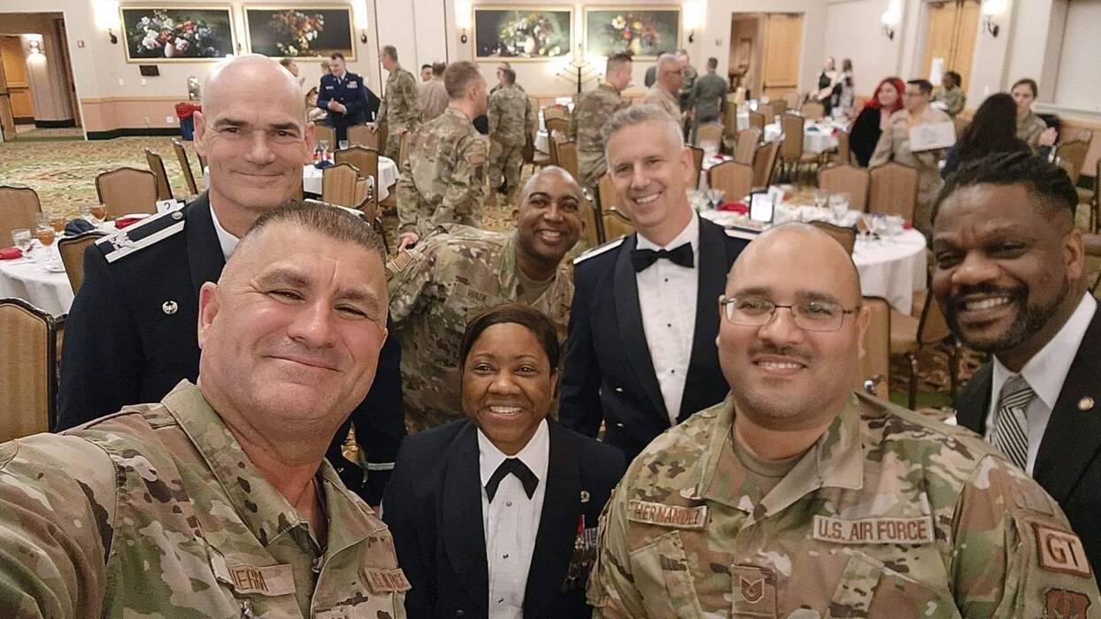 Col. William Gutermuth, left, 433rd Airlift Wing Commander, Col. Brendon Bartholomew, right, 433rd AW deputy commander, and Chief Master Sgt. Takesha Williams, center, 433rd AW command chief, pose with banquet attendees at the annual award ceremony Feb. 3, 2024, at Joint Base San Antonio-Lackland, Texas. (U.S. Air Force photo by Master Sgt. Juan Guerra)