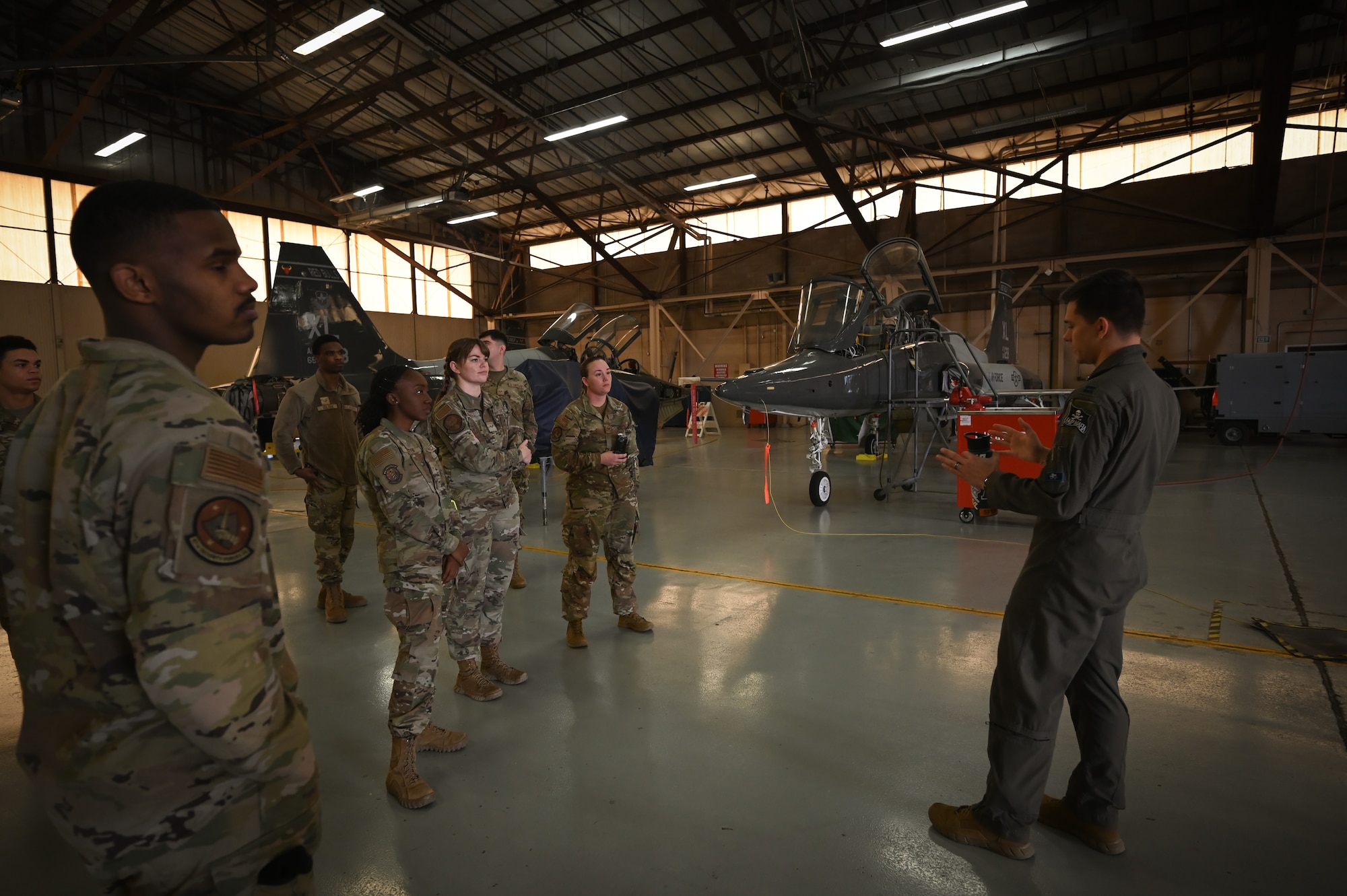 U.S. Air Force Senior Airman Philip Payne, 47th Operation Support Squadron air traffic controller, speaks to a group of Airmen about working in the radar approach control system (RAPCON) during a flight operations immersion tour at Laughlin Air Force Base, Texas, Feb. 1, 2024.
