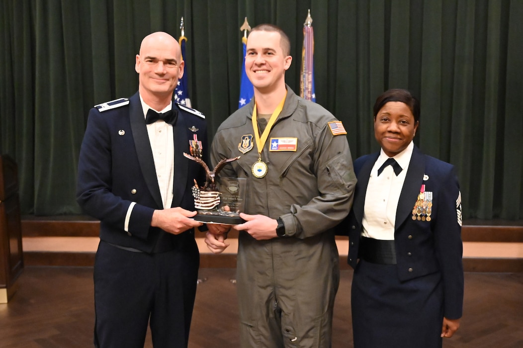 Col. William Gutermuth, 433rd Airlift Wing commander, and Chief Master Sgt. Takesha Williams, 433rd AW command chief, present the Senior Noncommissioned Officer of the Year award to Master Sgt. Joshua Green, 356th Airlift Squadron, at the wing’s annual awards ceremony Feb. 3, 2024, at Joint Base San Antonio-Lackland, Texas. (U.S. Air Force photo by Tech. Sgt. Jacob Lewis)