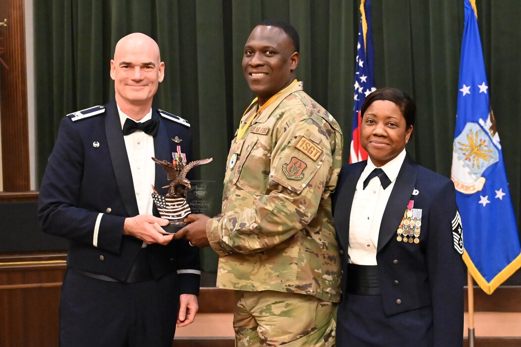 Col. William Gutermuth, 433rd Airlift Wing commander, and Chief Master Sgt. Takesha Williams, 433rd AW command chief, present the First Sergeant of the Year award to Master Sgt. Jevon King, 74th Aerial Port Squadron, at the wing’s annual awards ceremony Feb. 3, 2024, at Joint Base San Antonio-Lackland, Texas. (U.S. Air Force photo by Tech. Sgt. Jacob Lewis)