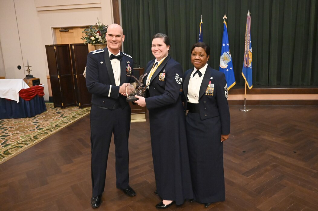 Col. William Gutermuth, 433rd Airlift Wing commander, and Chief Master Sgt. Takesha Williams, 433rd AW command chief, present the Noncommissioned Officer of the Year award to Tech. Sgt. Venus Rich, 433rd Security Forces Squadron, at the wing’s annual awards ceremony Feb. 3, 2024, at Joint Base San Antonio-Lackland, Texas. (U.S. Air Force photo by Tech. Sgt. Jacob Lewis)