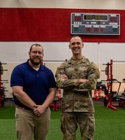 U.S. Army Capt. Robert Martinusek, the unit control officer assigned to 1st Infantry Division Sustainment Brigade Holistic Health and Fitness Team, 1st Infantry Division alongside DOD Civilian Justin Anderson,1st Inf. Div. Sust. Bde. H2F,  stand for a photo at Long Fitness Center on Fort Riley, Kansas, Feb. 13, 2024. The H2F team spreads knowledge, information and resources to Soldiers to help them maintain healthy lifestyles. (U.S. Army photo by Pfc. Autumn Johnson)