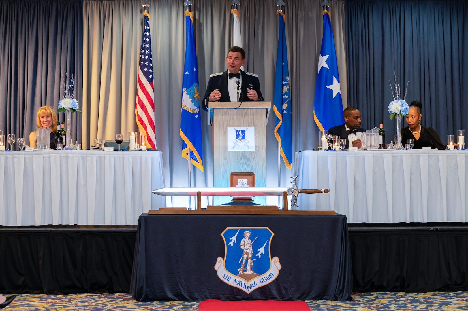 U.S. Air Force Lt. Gen. Michael A. Loh, standing, director, Air National Guard, at his induction ceremony into the Order of the Sword at the U.S. Air Force Academy, Colorado Springs, Colorado, Feb. 15, 2024. Loh was inducted for supporting the development and welfare of Airmen.