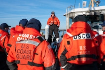 A photo of a man speaking to a crew.